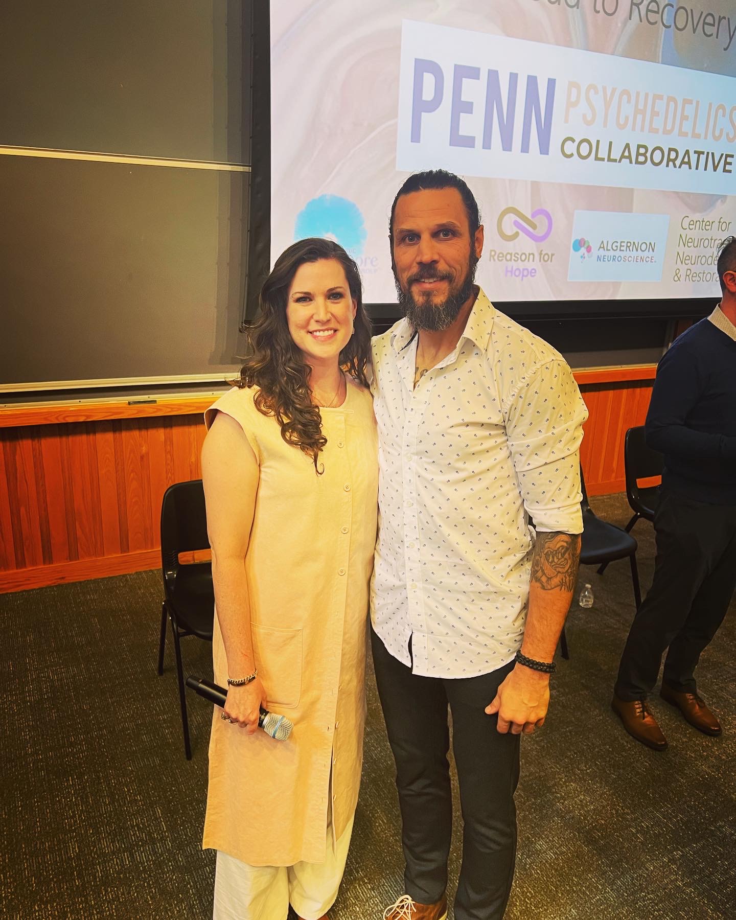 Mia Lowry with a speaker at a Penn Psychedelics Collaborative event